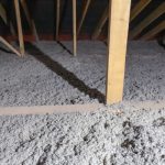 Tap insulation coats the floor of a home's attic.