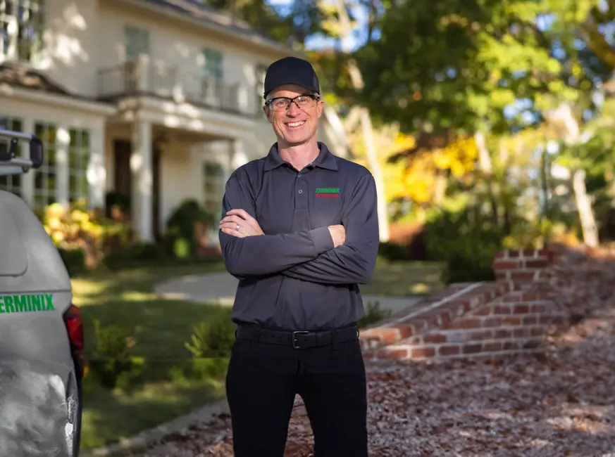 Pest control technician with a customer in front of their home - Keep pests away with Terminix Anderson