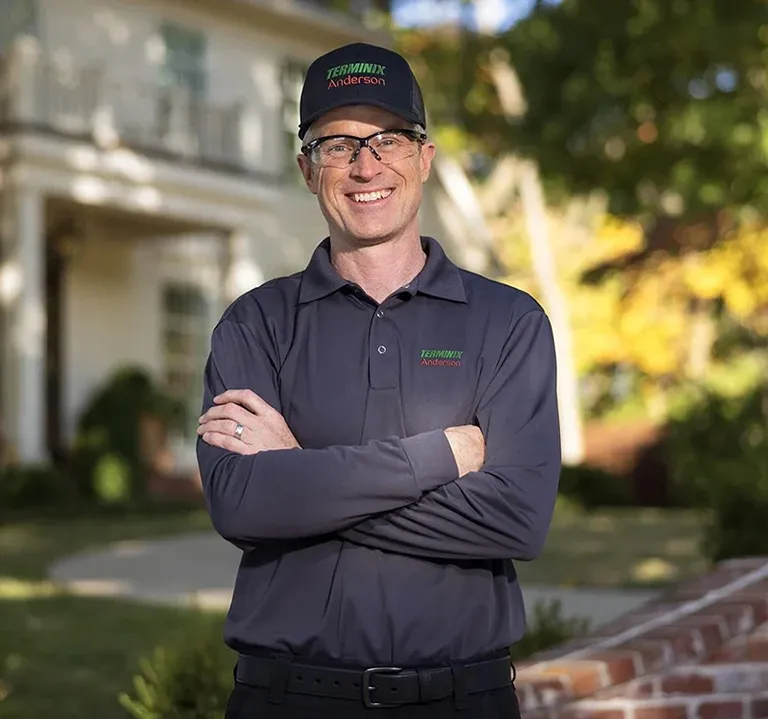 Terminix Anderson pest control technician in front of a residential home
